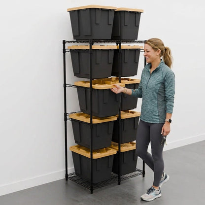 A woman stands next to a black bin rack that holds ten 12-gallon black and yellow storage bins.