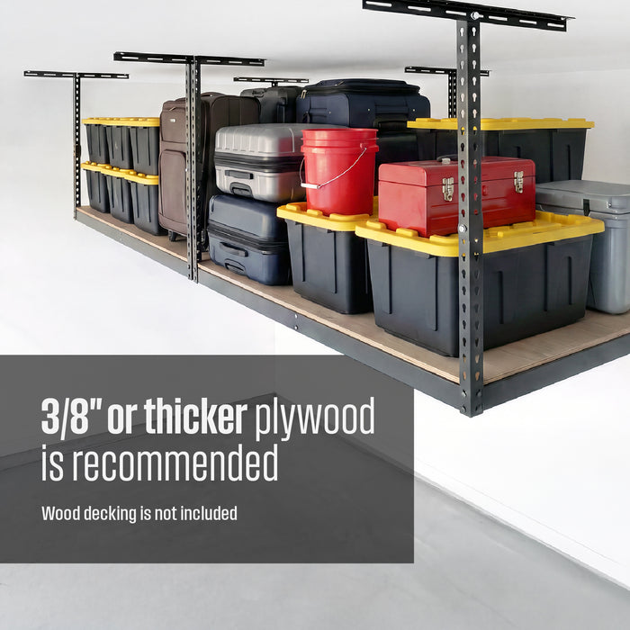 An overhead storage rack with plywood decking filled with storage bins, suitcases, and garage gear. Text overlay reads "3/8 inch of thicker plywood is recommended, wood decking is not included"