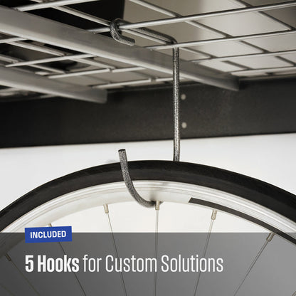Close-up of a textured grey metal hook hanging from a garage shelf, with a bicycle tire partially visible to demonstrate use. Text overlay reads 'INCLUDED 5 Hooks for Custom Solutions'.