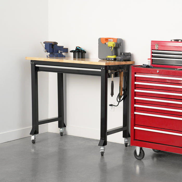 Workbench with tools and a red toolbox in a workshop setting.