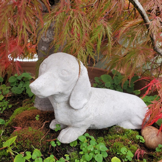 Small concrete dachshund dog statue