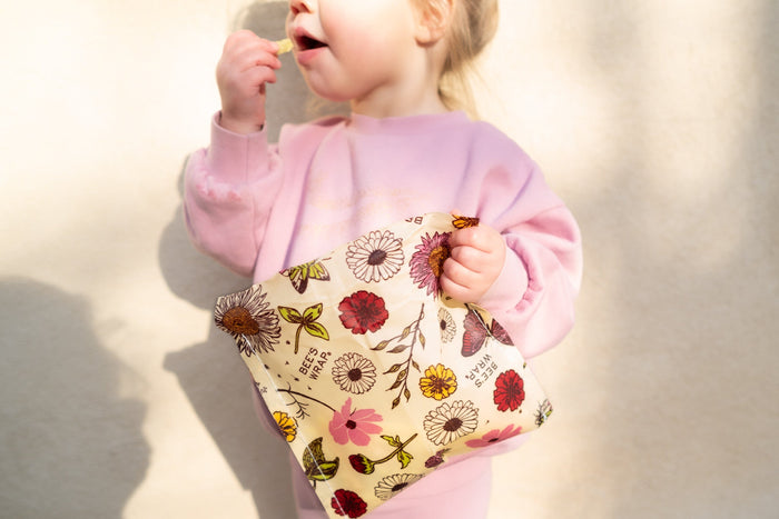 Child holding a Bee's Wrap snack wrap